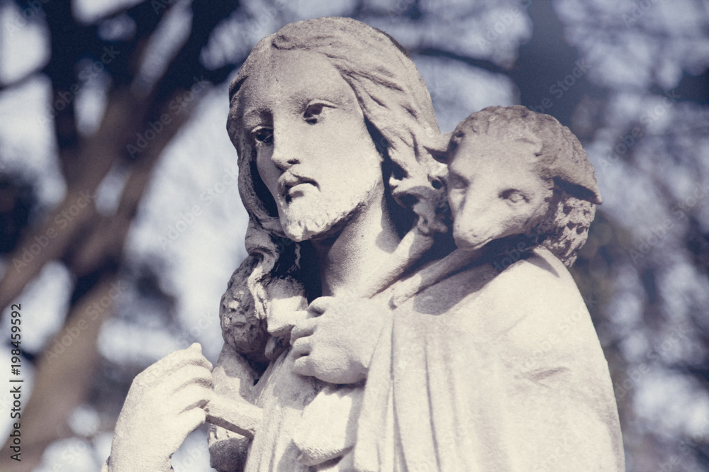 Fragment of acient statue of Jesus Christ is the Good Shepherd with the lost sheep on his shoulders. (Biblical tradition, religion, Christianity, God, faith concept) Fragment of acient statue of Jesus Christ is the Good Shepherd with the lost sheep on his shoulders. (Biblical tradition, religion, Christianity, God, faith concept)