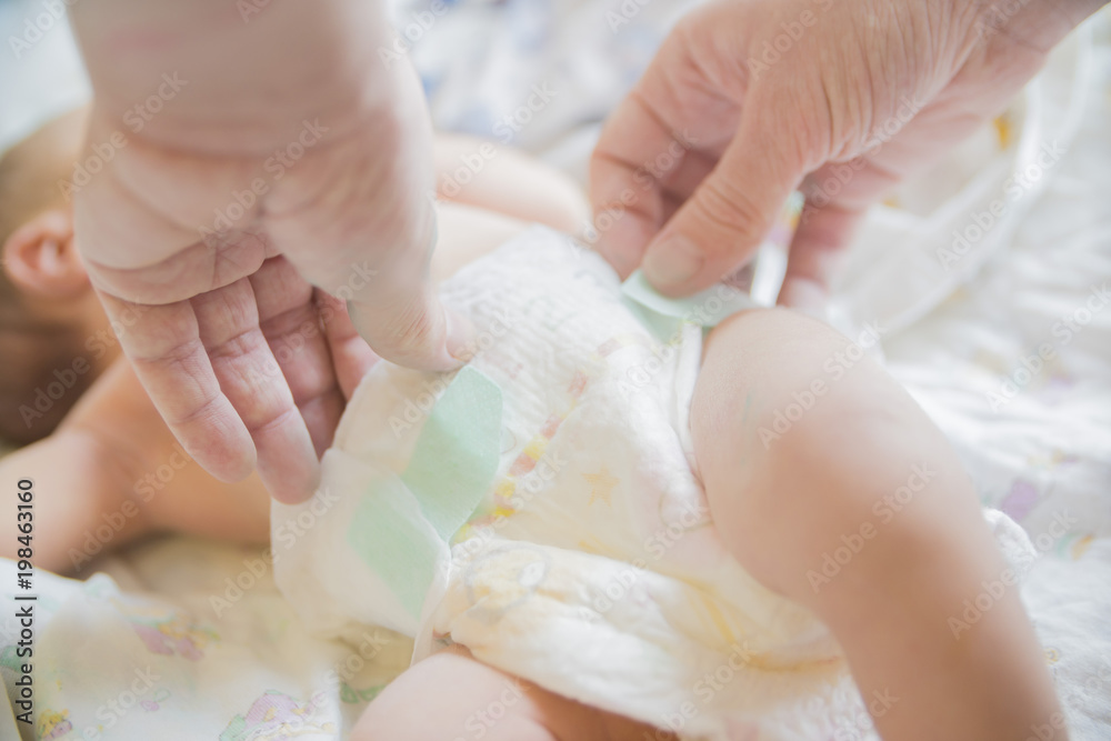 Obraz premium close-up of hands wearing baby diapers