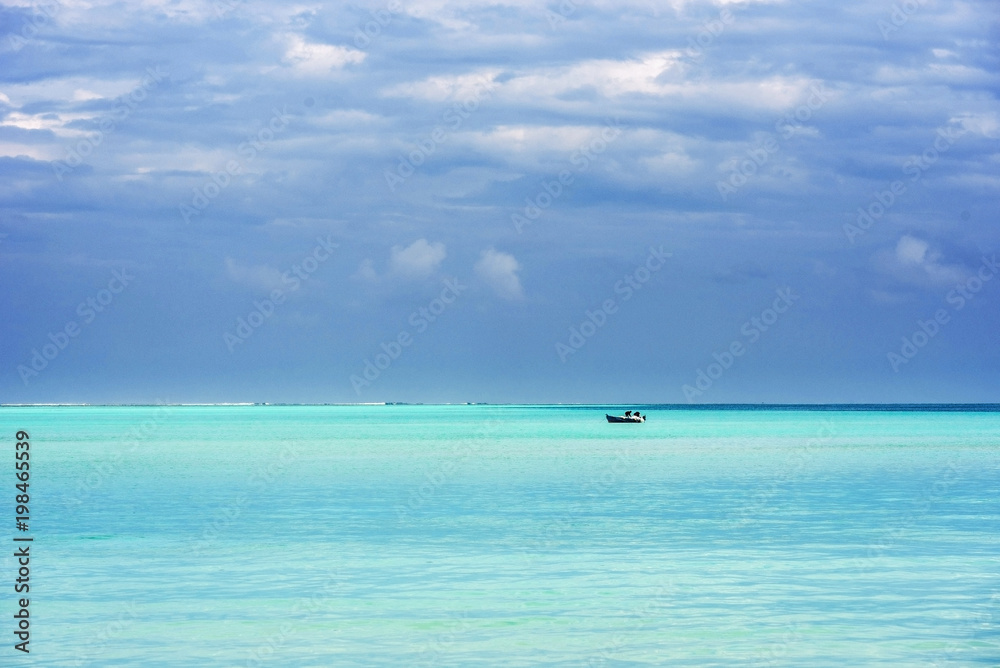 Lonely boat in the Indian ocean, Male, Maldives. Copy space for text.
