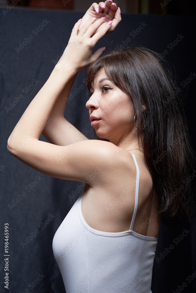 Fototapeta premium Sexy curvy brunette in white body on a black background