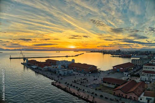explosion of colors from the sunset above the harbor in the city of Thessaloniki, Greece © ververidis