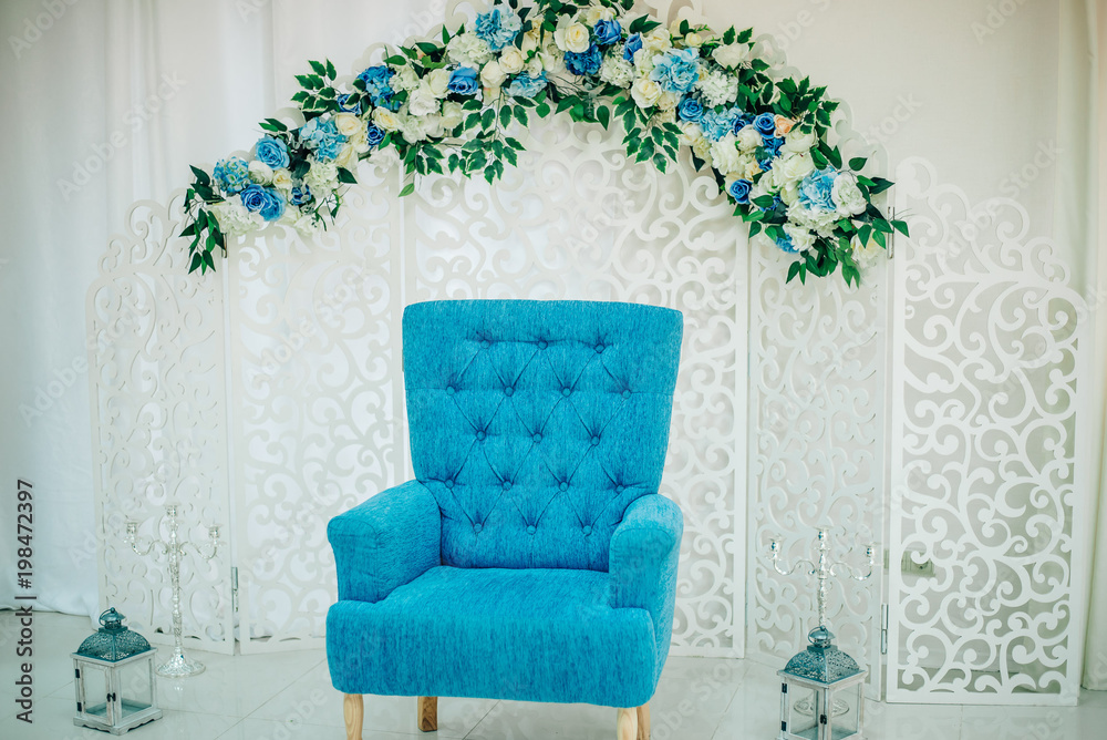 Interior with a white wooden screen decorated with flowers. Blue classic  stylish chair. Studio background Stock Photo | Adobe Stock