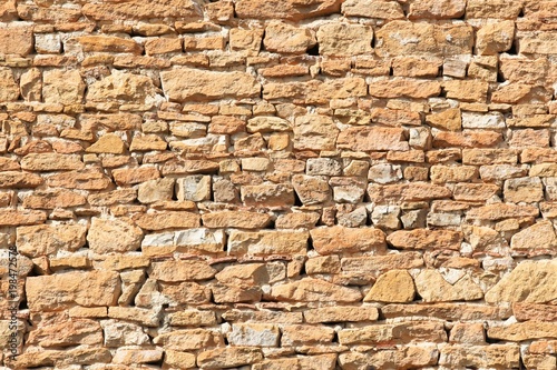 Background of orange stone wall texture in Beaujolais, France