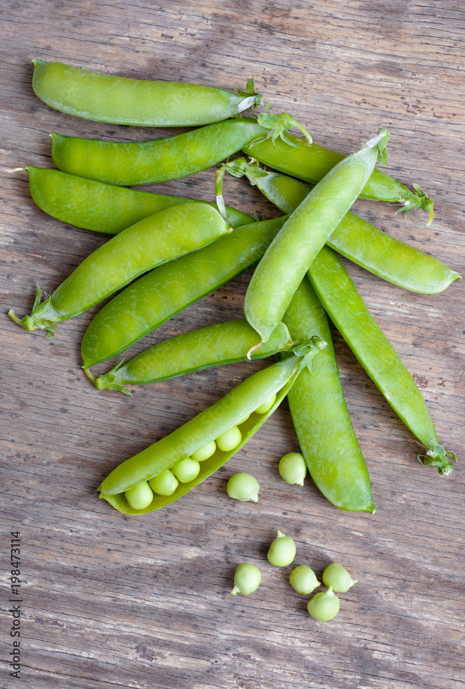 Fresh Green peas over wooden background Fresh Green peas over wooden background