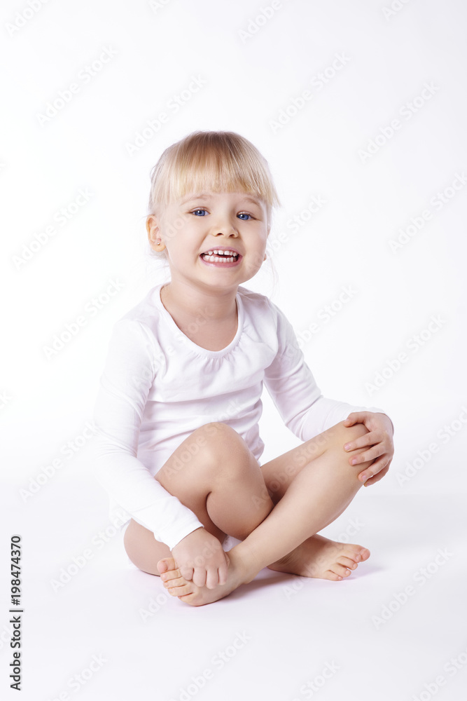 Barefoot girl sitting on floor at studio shot . Barefoot girl sitting on floor at studio shot .
