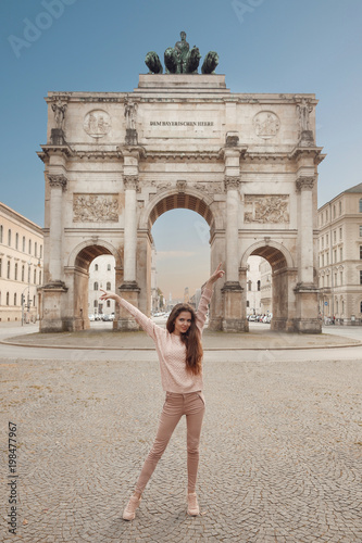 Victory Gate triumphal arch Siegestor in Munich, Germany. Tourist woman in front of attraction landmark travel background. © Victoria Andreas