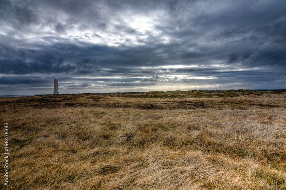 A simple little lighthouse provides the perfect subject on a dramatic sunset in Iceland A simple little lighthouse provides the perfect subject on a dramatic sunset in Iceland