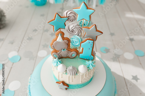 Baby birthday cake, gingerbread and bisquit decor. Tiffany color background. photo