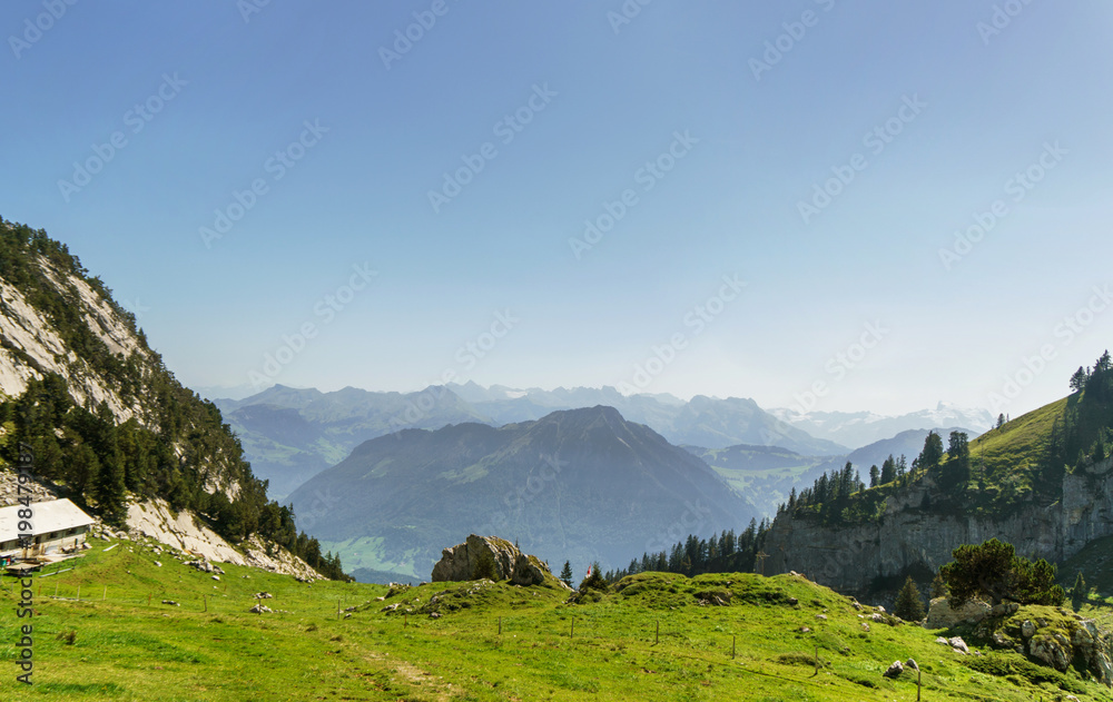 Alpine landscape with green meadow and mountains near Luzern, Switzerland.