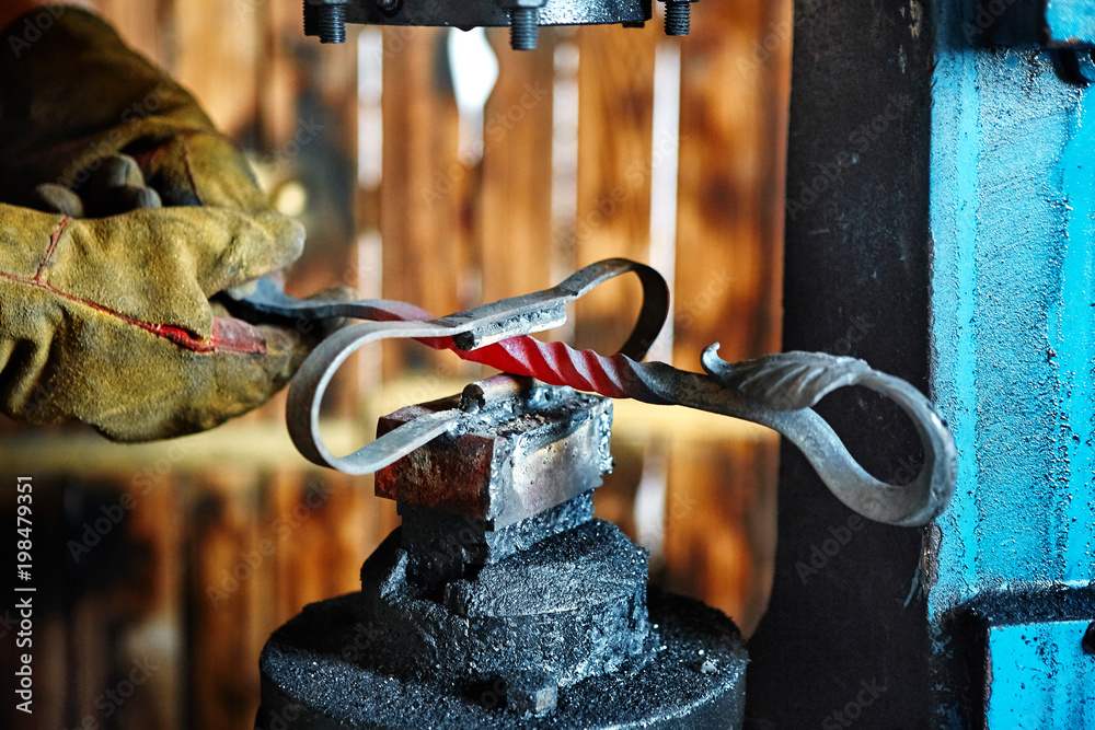 Forging press. Manufacturer of wrought iron decorative items for pneumatic  forging machine foto de Stock | Adobe Stock