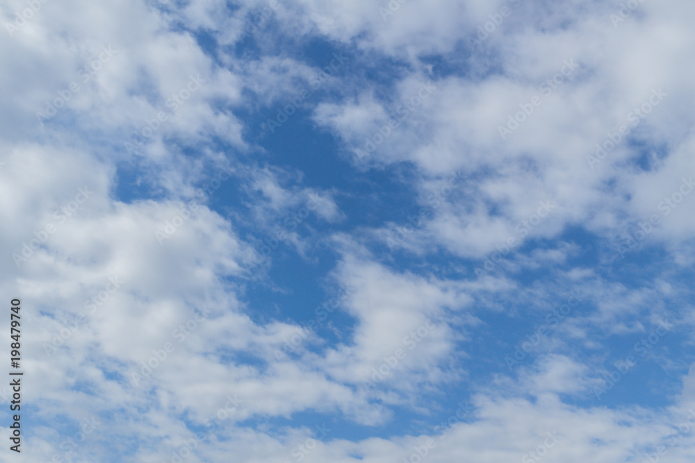 Blue sky background with clouds. White clouds on blue sky. Blue sky with clouds closeup. Natural background Blue sky background with clouds. White clouds on blue sky. Blue sky with clouds closeup. Natural background