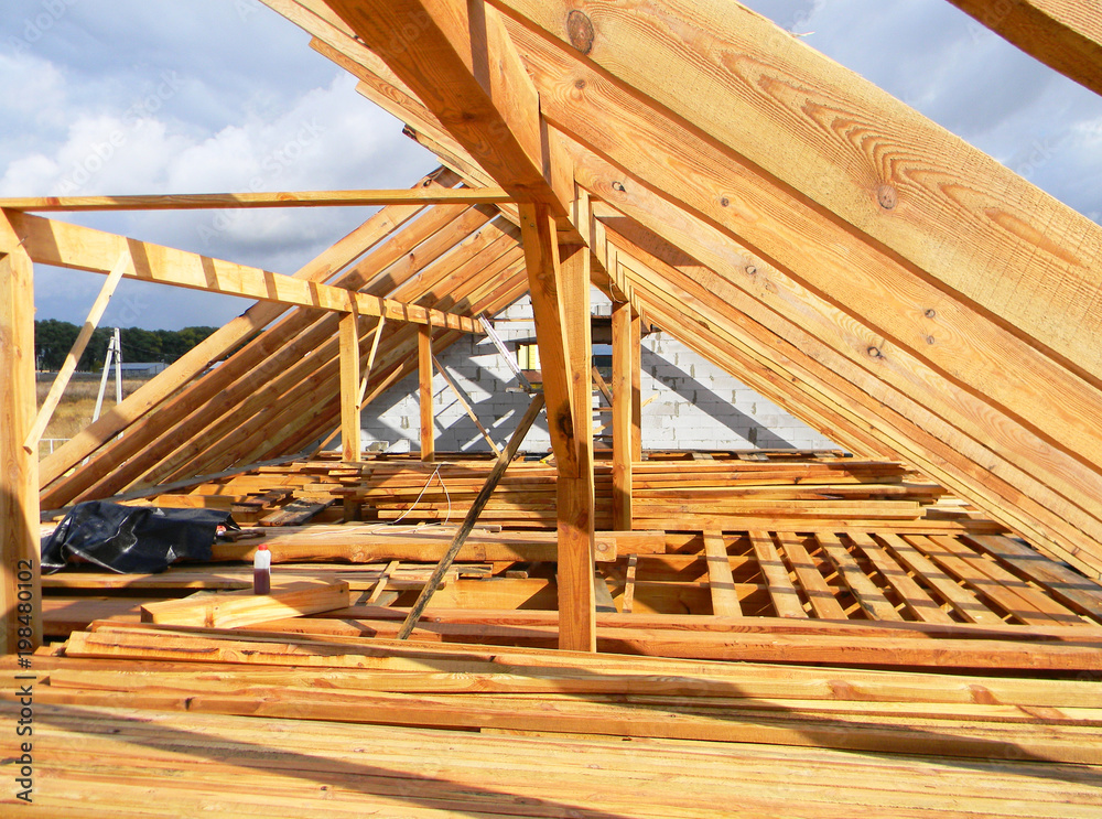 Installing wooden beams, logs, timber, rafters, trusses for house attic construction. Roofing construction. Installing wooden beams, logs, timber, rafters, trusses for house attic construction. Roofing construction.
