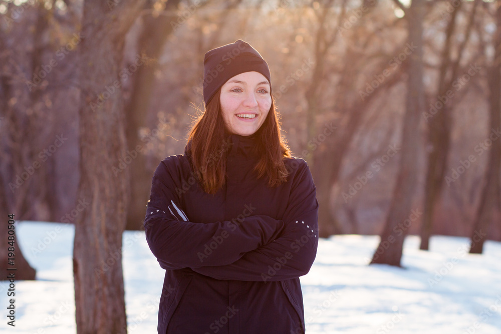 young woman athlete in black sport suit run in winter park young woman athlete in black sport suit run in winter park