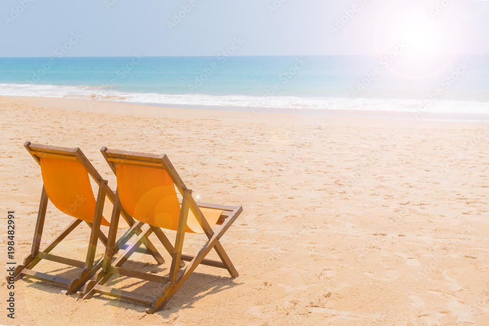 Beach chairs on the sandy beach of the ocean.