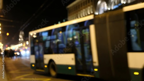 Blurred bus on the street at night.