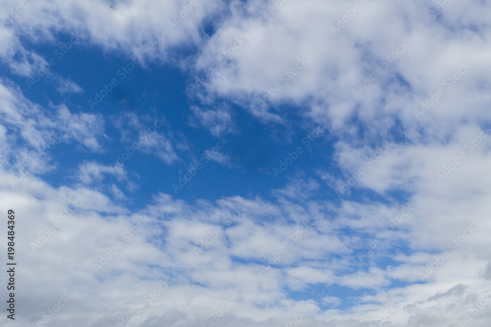 Blue sky background with clouds. White clouds on blue sky. Blue sky with clouds closeup. Natural background Blue sky background with clouds. White clouds on blue sky. Blue sky with clouds closeup. Natural background