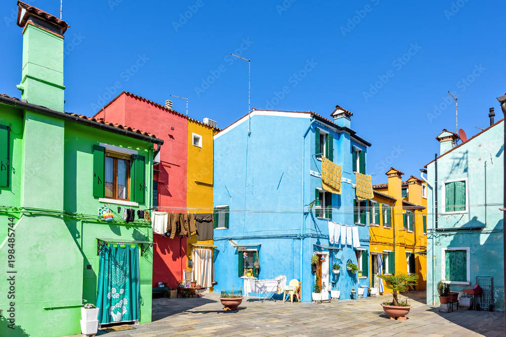 Daylight view to vibrant house front facades with clothes drying