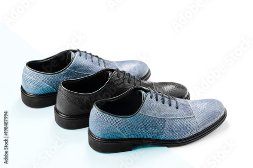 Classic male black and blue leather shoes on a white. Male fashion concept.  Flat lay, top view