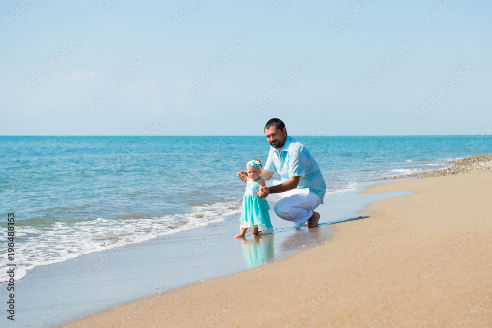 Happy father and his sweet little daughter at beach