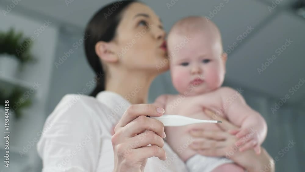 Mother with thermometer and baby on a hands Mother with thermometer and baby on a hands