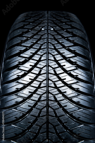 Clean Tyre. Black new shiny car tire background.