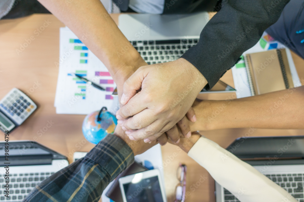 Business teamwork. Business man coworkers with joined hands together. Team work people.