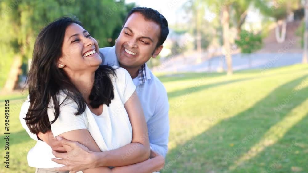 Closeup portrait, young couple in blue and white shirt, having fun with each other, isolated outdoors outside background. Happy moments, positive emotions Closeup portrait, young couple in blue and white shirt, having fun with each other, isolated outdoors outside background. Happy moments, positive emotions
