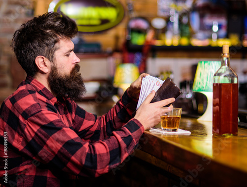 Hipster holds wallet, counting money to buy drinks