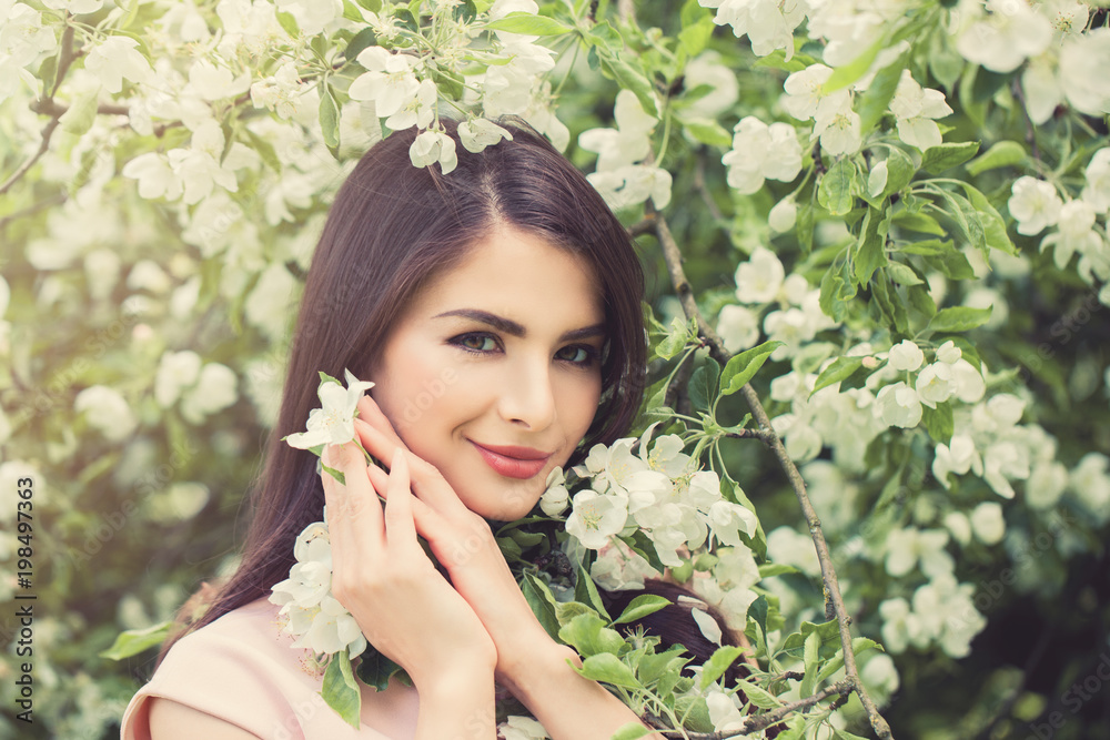 Beautiful Young Woman with Spring Flowers on Floral Spring Background, Female Face Closeup Beautiful Young Woman with Spring Flowers on Floral Spring Background, Female Face Closeup