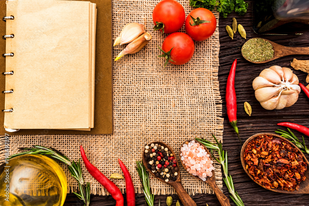 Open cook book and various spices composition Open cook book and various spices composition