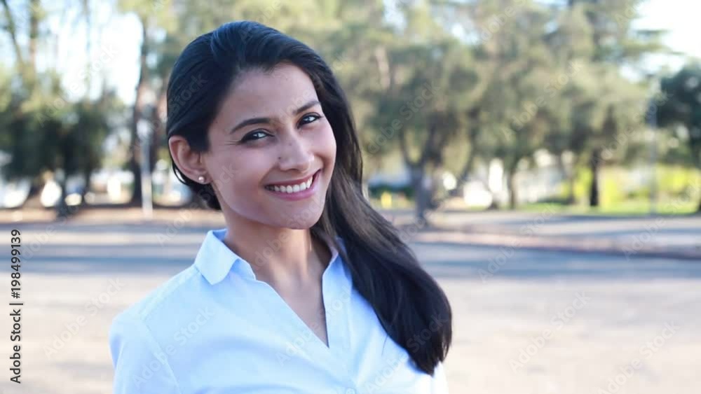Closeup portrait, young businesswoman in blue shirt posing outdoors, isolated outside background. Positive human emotions Closeup portrait, young businesswoman in blue shirt posing outdoors, isolated outside background. Positive human emotions