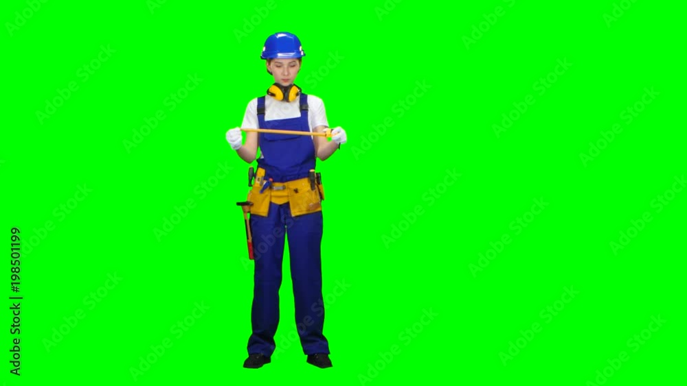 Builder takes measurements with the help of a tape measure. Green screen Builder takes measurements with the help of a tape measure. Green screen