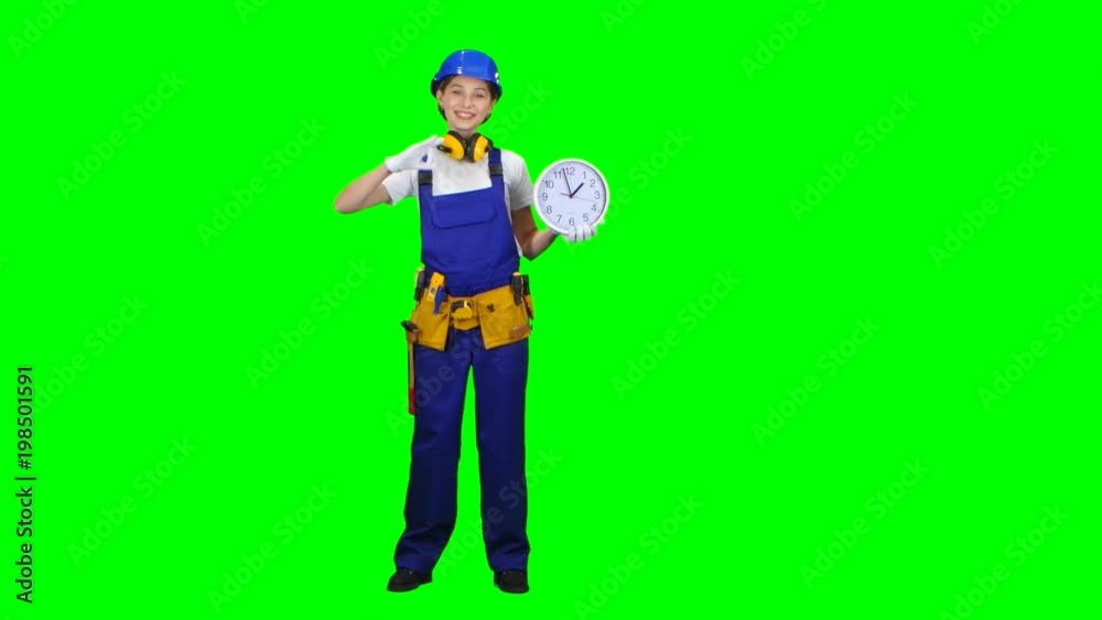 Brigadier girl is holding a large clock and showing okay. Green screen Brigadier girl is holding a large clock and showing okay. Green screen