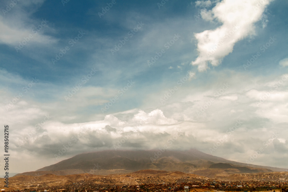 Misti volcano covered by clouds with Arequipa neighborhood (Peru) at its base Misti volcano covered by clouds with Arequipa neighborhood (Peru) at its base