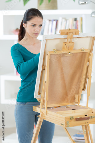 female artist drawingpainting a picture at home