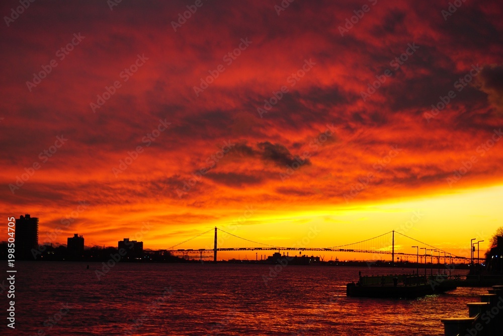 Red sunset over the bridge from Detroit to Canada