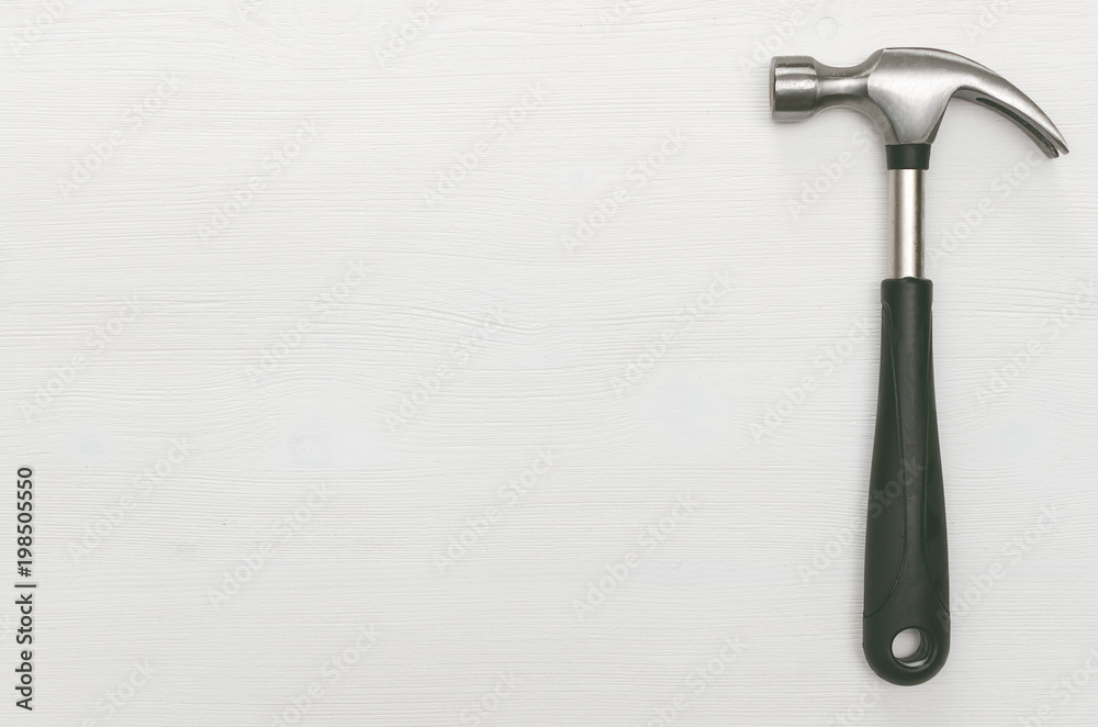 Hummer tool isolated on white wooden surface background with copy space. Construction concept background. Hummer tool isolated on white wooden surface background with copy space. Construction concept background.