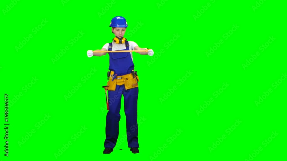Engineer takes measurements with the help of a tape measure. Green screen Engineer takes measurements with the help of a tape measure. Green screen