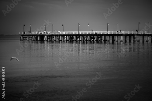 Fototapeta Naklejka Na Ścianę i Meble -  Sea pier at the Baltic Sea shoreline in Gdynia Orlowo, Poland at evening twilight