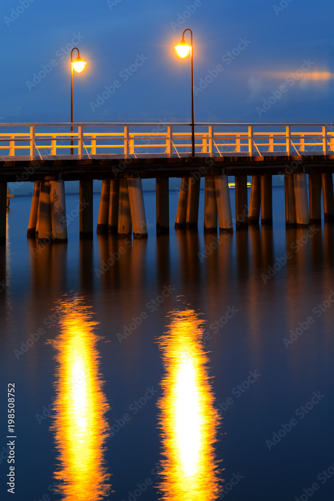 Sea pier at the Baltic Sea shoreline in Gdynia Orlowo, Poland at evening twilight