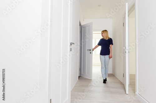 Sexy young woman standing in the door