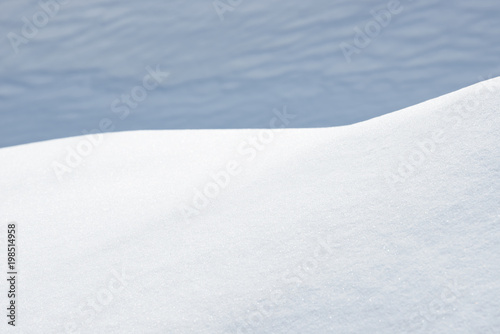 Fresh snow background texture. Winter background with snowflakes and snow mounds.