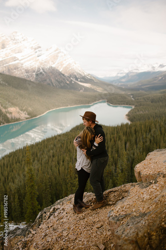In Love Man and Woman Couple Hugging By A Mountain Lake