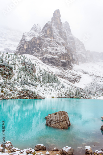 The mountain lake Lago di Sorapiss in Dolomite Alps. Italy, with amazing turquoise color of water. photo
