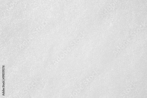 white even sparkling snow. texture uniform background. top view