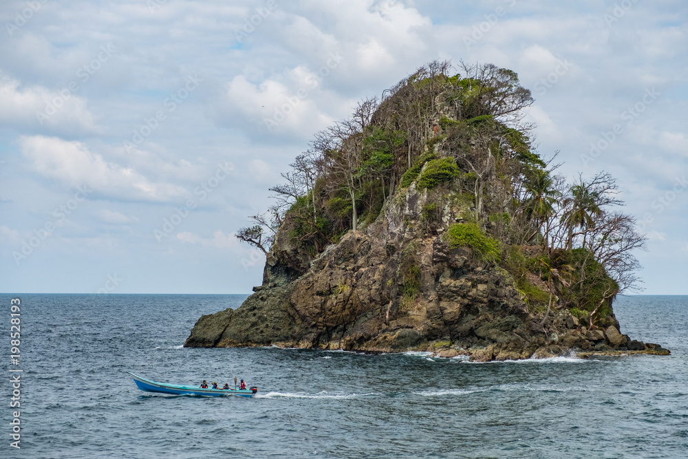 Naklejka premium small island , ocean and small boat