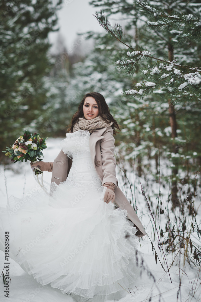The bride against the winter snow-covered forest of firs and pines 851.
