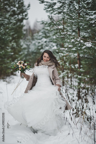 The bride against the winter snow-covered forest of firs and pines 853.
