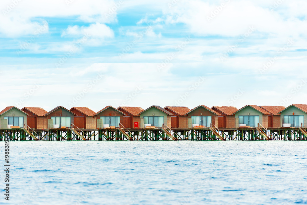 Water villas on tropical caribbean island, Maldives. Copy space for text.
