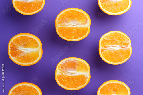 Sliced fruit oranges in checkered pattern on a purple background  symmetrically laid out citrus in pop art style  fruit pattern of halves of oranges  ultraviolet  minimalism